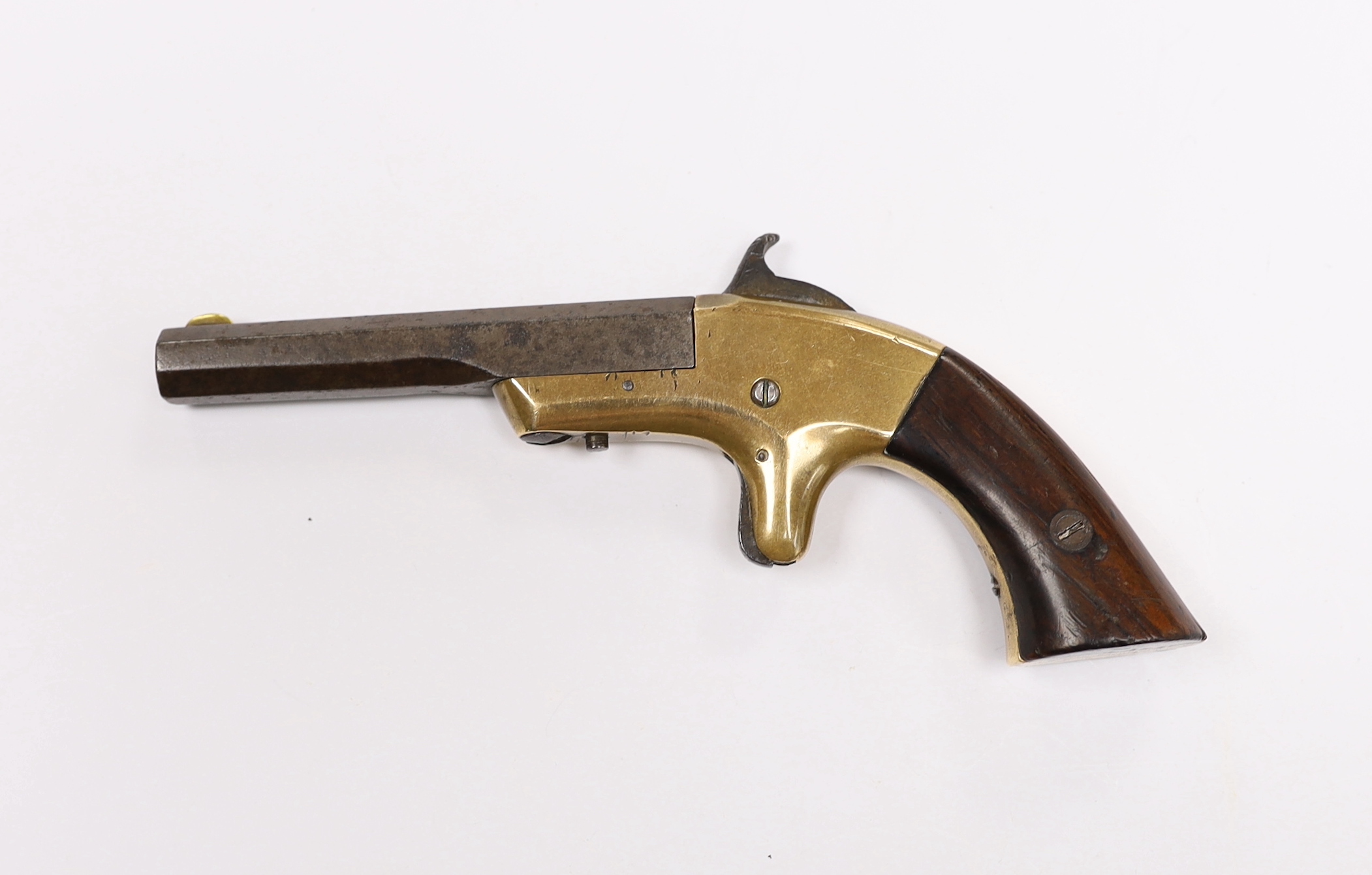 A 19th century miniature percussion pistol with brass lock and octagonal barrel, stamped Morgan and Clapp Newhaven CT, barrel 9cm